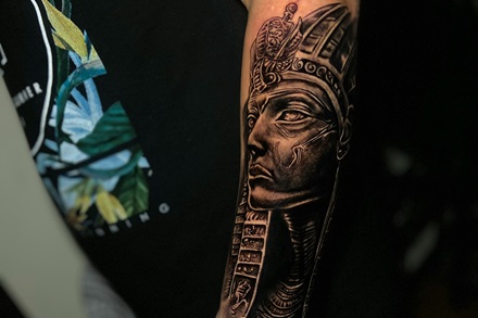 forearm sleeve tattoo of black and gray pharaoh