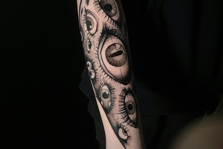 forearm sleeve tattoo of black and gray realism eyes