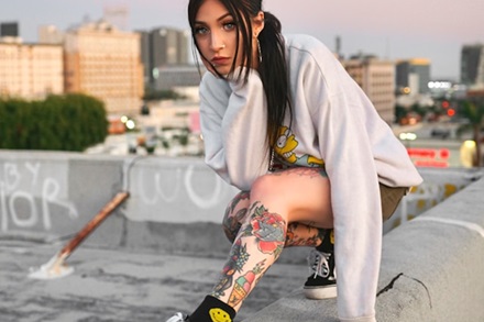 girl posing with a traditional leg sleeve tattoo