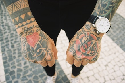 photo of two different rose tattoos on someones hands